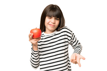 Little girl with an apple over isolated chroma key background making doubts gesture while lifting the shoulders