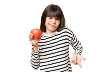 Little girl with an apple over isolated chroma key background making doubts gesture while lifting the shoulders