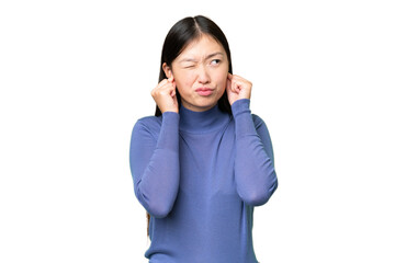 Young Asian woman over isolated chroma key background frustrated and covering ears