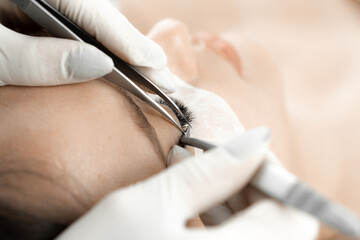 A photo that conveys the ability cosmetologist to create perfect look of eyelashes. Each eyelash is arranged with attention to detail, accentuating eyes and giving face attractiveness in beauty salon