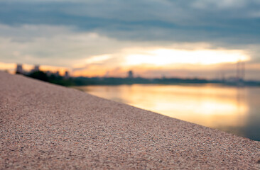granite texture on the background Blurred image of the sunset over the river.