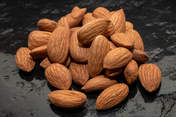 organic almond (prunus dulcis) on stone or concrete background