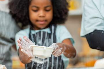 african afro black daughter kids sifting flour powder and sprinkling ingredients on massaging dough for bakery cooking. Black african daughter afro hair enjoy sifting flour wheat by sieve in kitchen
