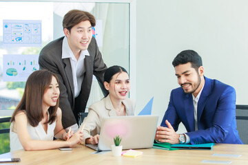 Millennial Asian Indian multinational professional successful businessmen and businesswomen in formal suit helping brainstorming working as teamwork via laptop notebook computer in company office