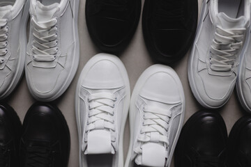 Six pairs of black and white sneakers on the floor. Casual fashion style minimalistic shoes. - Powered by Adobe