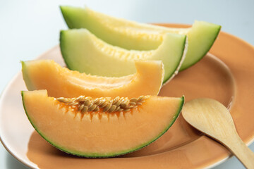 Honeydew melon and Japanese melon slice fresh ripe orange and sweet green slice lay on leaf in plant. Melon or cantaloupe is sweet fruit dessert.