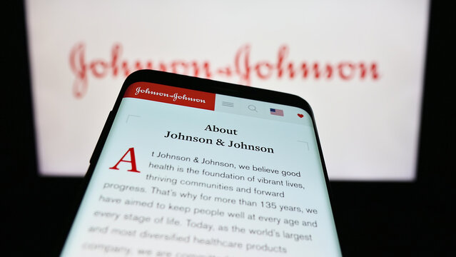 Stuttgart, Germany - 07-29-2023: Mobile phone with website of US company Johnson and Johnson (JNJ) on screen in front of business logo. Focus on top-left of phone display.