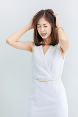 Fototapeta premium Isolated cut-out studio portrait of beautiful asian professional successful businesswoman in business attire having stress, headache, standing on white background.