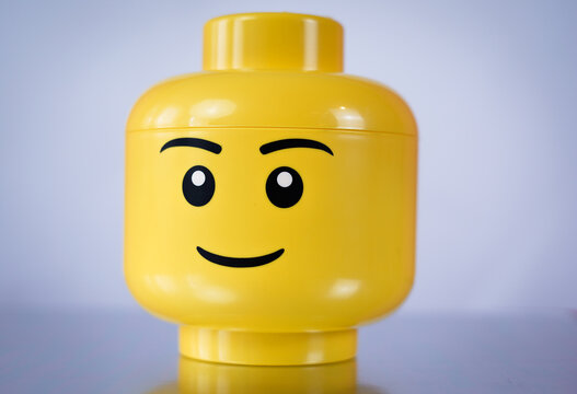 Yellow lego head on grey background, 15 September 2023, Poland.