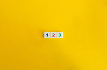 123 Concept. Letter Tiles on Yellow Background. Minimal Aesthetic.