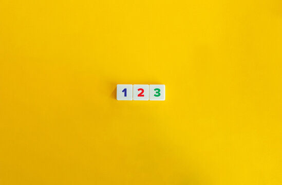 123 Concept. Letter Tiles on Yellow Background. Minimal Aesthetic.