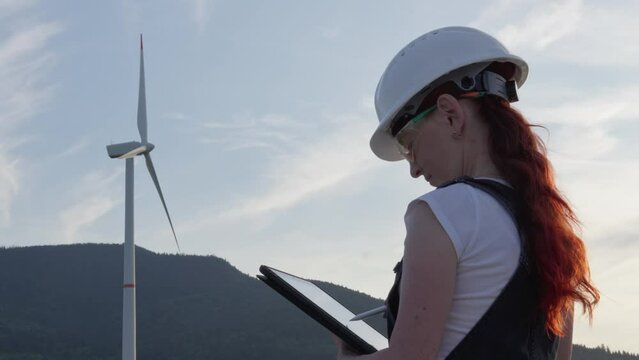 The video demonstrates the work of an engineer who analyzes and monitors the operation of a wind turbine, ensuring uninterrupted production of environmentally friendly electricity. Woman works at work