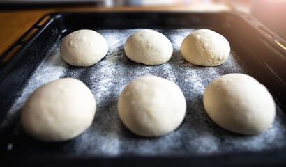 Fototapeta na wymiar Dough balls are resting and waiting to be turned into pizza