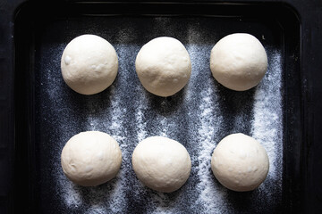 Dough balls are resting and waiting to be turned into pizza