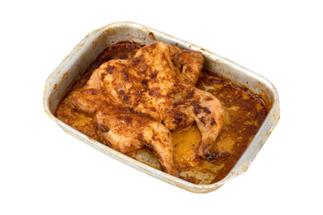 Baked chicken on a baking sheet. Chicken baked in the oven on a baking sheet close-up isolated on a white background.