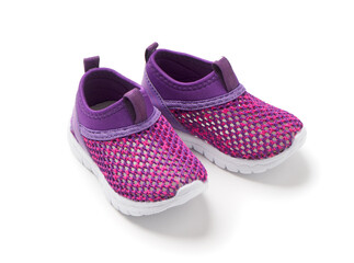 Sports shoes for children on a white background. Pink casual sneakers with white soles.