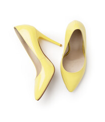 Elegant women's summer leather yellow patent leather stilettos. A new pair of shoes on a white background.
