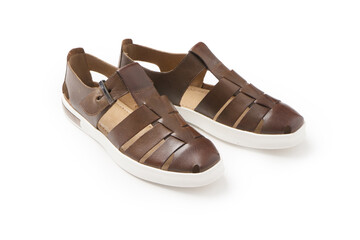 Naklejka premium Men's brown summer leather sandals with white soles. A new pair of shoes on a white background.