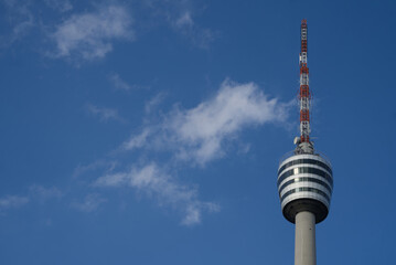 Stuttgart TV tower in the sunlight with fair weather clouds