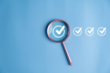 Magnifier enlarging the correct or check mark on blue background. Business industrial quality...