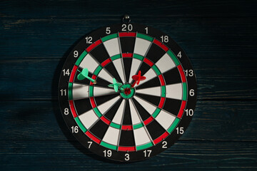 Darts for hitting the target, playing darts on a dark background.
