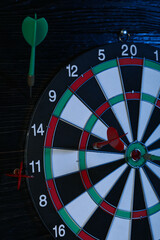 Darts, hitting the target, with wires, on a dark background.