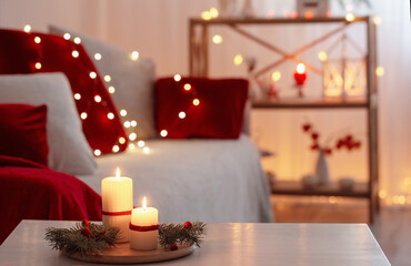 christmas decor in red color with burning candles at home