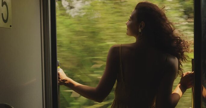 Travel and Exploration of Tourist Woman by Train to Famous Landmarks in Sri Lanka. Romantic young traveler woman enjoying an extremely fun train ride from Ella to Kandy among rainforest in the