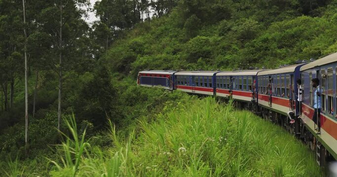 Sri Lanka train ride through mountain rainforests and railway tunnels. High-quality slow motion 4k footage