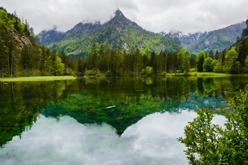 Fototapeta premium lake with wonderful reflections from the mountains and green hills