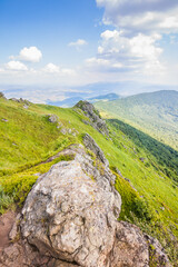 Beautiful view of the Ukrainian mountains Carpathians and valleys.Beautiful green mountains in summer with forests, rocks and grass. Water-making ridge in the Carpathians, Carpathian mountains