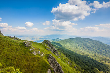 Fototapeta na wymiar Beautiful view of the Ukrainian mountains Carpathians and valleys.Beautiful green mountains in summer with forests, rocks and grass. Water-making ridge in the Carpathians, Carpathian mountains