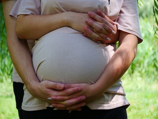 Photo session for a pregnant woman in the fresh air