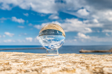 Fototapeta na wymiar View of the sea through the glass sphere
