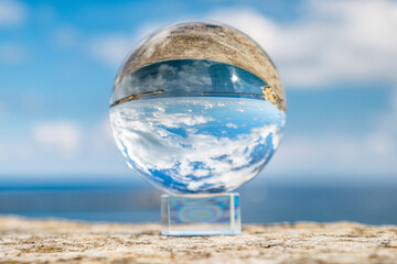 View of the sea through the glass sphere