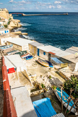 old colorful oars and fishing boats stored in front of small houses