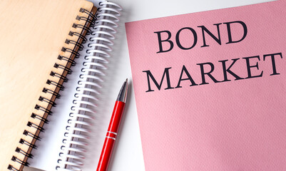 BOND MARKET word on the pink paper with office tools on white background