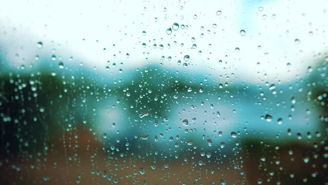 raindrop on the window in autumn a background. wet glass rain drops rainy sky blurred background close-up. rain in lifestyle the window on the background of the sky blurred plan