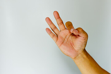 Hand with thumb and forefinger touching, showing three fingers on white background. Chakras concept. OK sign. Gestures all are well, done. 