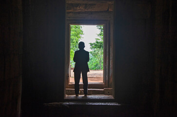 Silhouette man in entrance of ancient sandstone castle