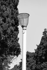 Black and white street light pole with lantern lamp. Light source
