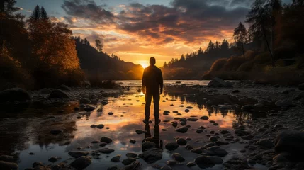 Photo sur Plexiglas Marron profond Sunset on the river, landscape nature with sunrise over water, man standing in river on rocks
