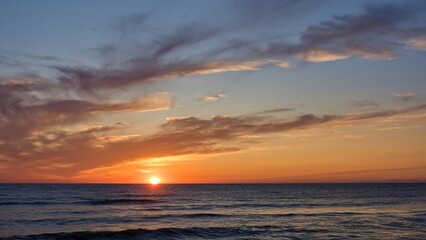 The sun is on the horizon. Beautiful seascape. Baltic Sea. Positive photography.