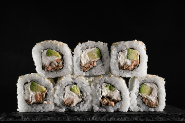 Set of rolls with tuna and cream cheese on a black background