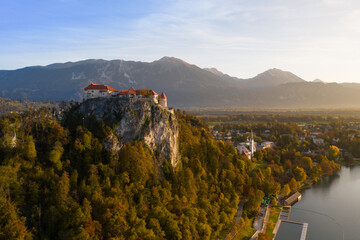 Bled Castle in autumn at sunset in Slovenia aerial view