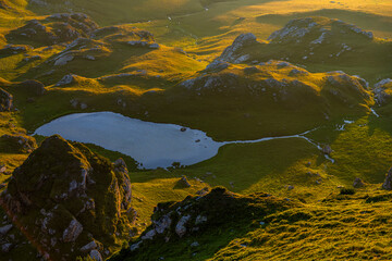 Mountain landscape with the rising sun. Dark background with a copy space. The Parang Mountains, Romania.
