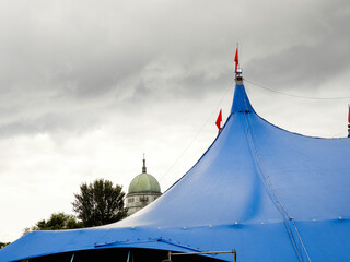 Blue tent roof and Galway Cathedral dome in Galway city, Ireland. Dark grey sky.