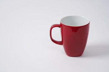 red ceramic coffee mugs on a white background