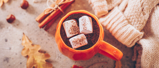 Mug with hot chocolate cacao with marshmallows, cozy warm sweater and cozy decoration. Autumn mood, hygge atmosphere. Flat lay, top view. Banner for web site - 631077188