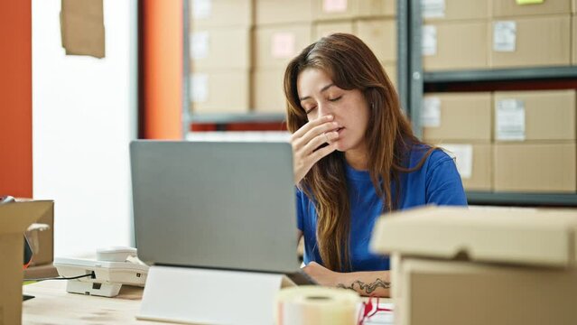 Young beautiful hispanic woman ecommerce business worker using laptop working stressed at office